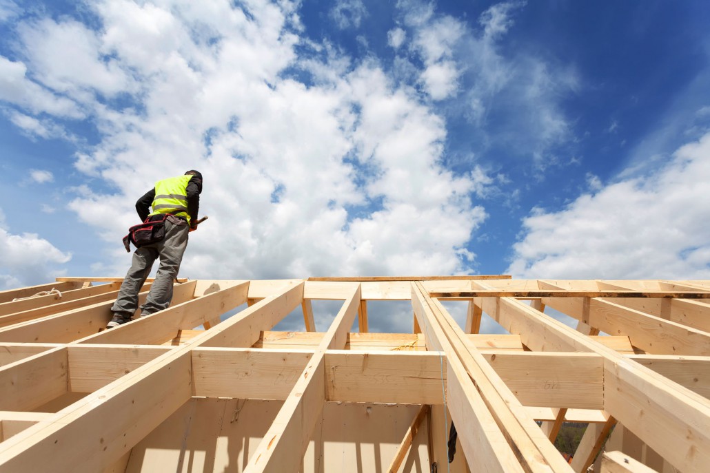 54731994 - construction crew working on the roof against blue sky
